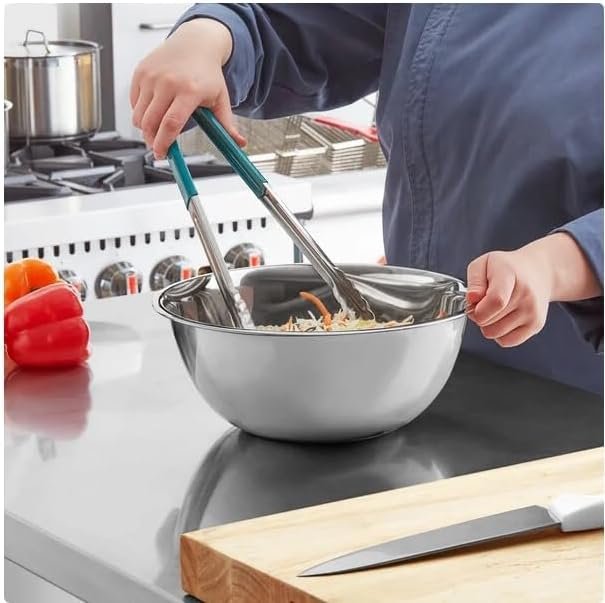 Stainless steel mixing bowl used with tongs during food preparation